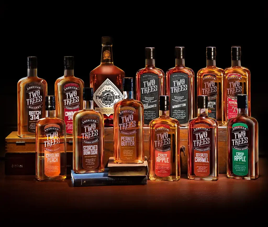 Group shot of 13 varieties of Two Trees Flavored Whiskey
