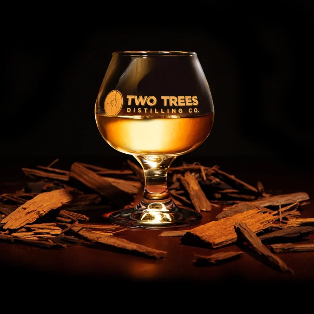 Sipping glass with Two Trees logo printed on the side